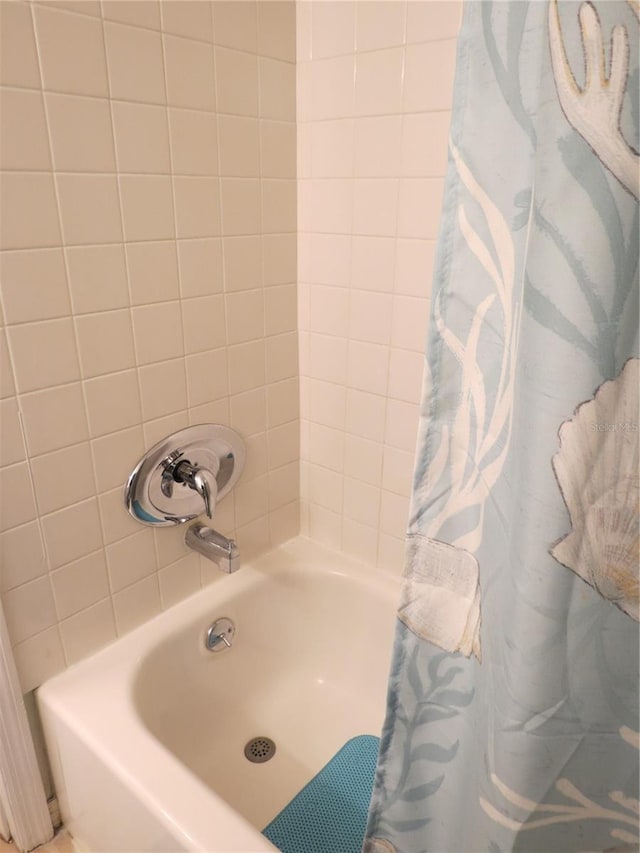 full bathroom with shower / bath combo with shower curtain