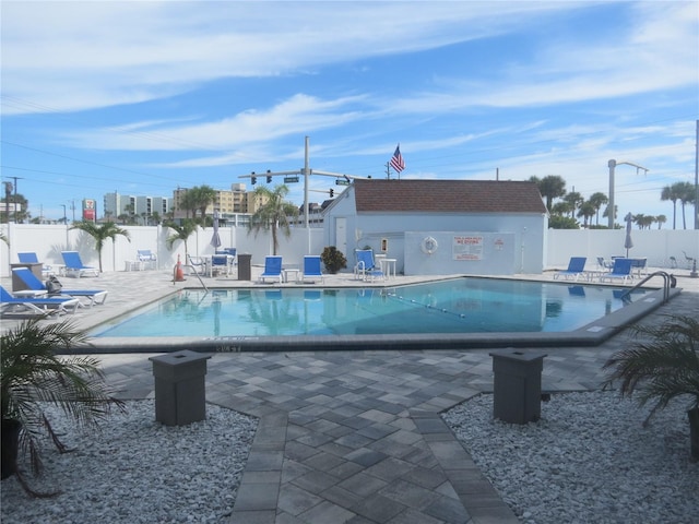 community pool featuring a patio and fence