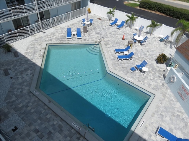 community pool featuring a patio and a fenced backyard