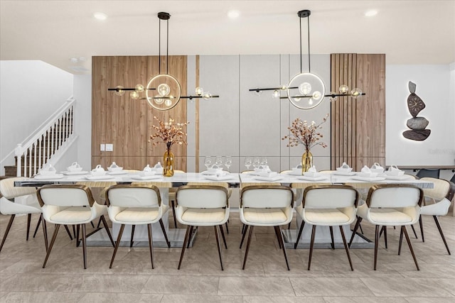 kitchen with decorative light fixtures, a kitchen breakfast bar, an inviting chandelier, and light tile patterned flooring