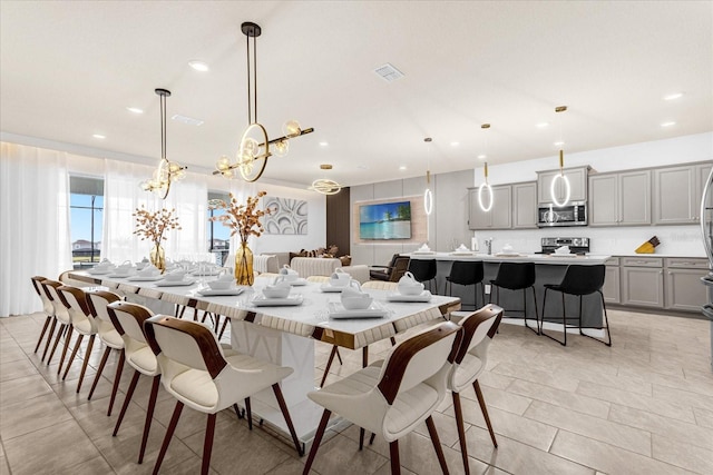 tiled dining room featuring a notable chandelier