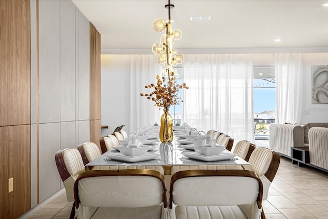 dining area with light tile patterned floors and an inviting chandelier