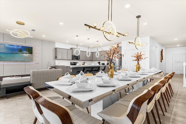 tiled dining space featuring an inviting chandelier