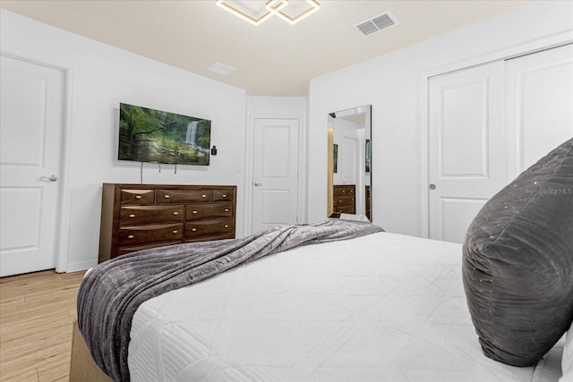 bedroom featuring light wood-type flooring and a closet