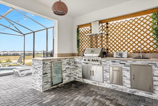 view of patio with sink, glass enclosure, grilling area, ceiling fan, and area for grilling