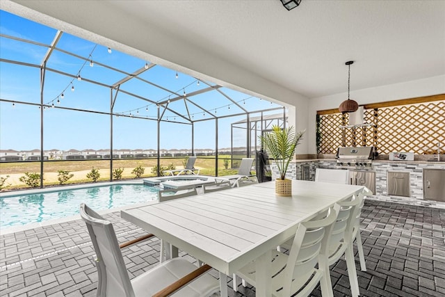 view of patio / terrace with a pool with hot tub, an outdoor kitchen, a grill, and a lanai