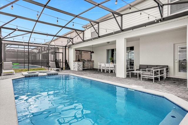 view of pool with an in ground hot tub, outdoor lounge area, glass enclosure, and a patio