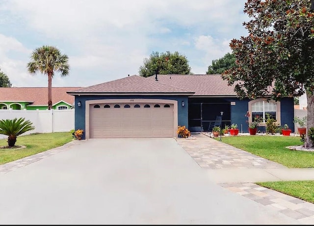 single story home featuring a garage and a front lawn