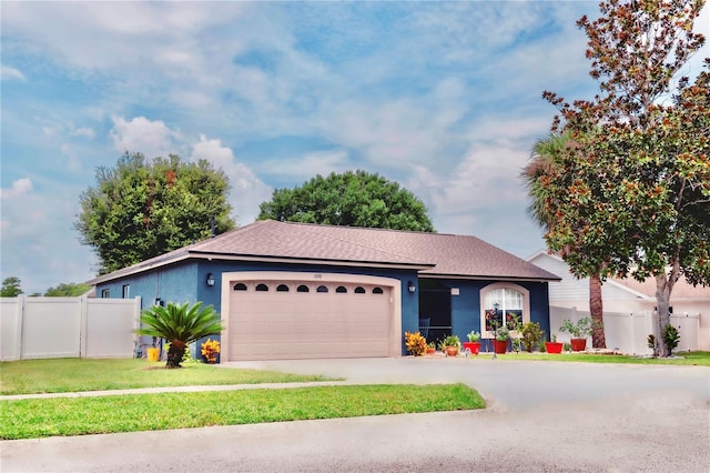 ranch-style home featuring a front yard and a garage