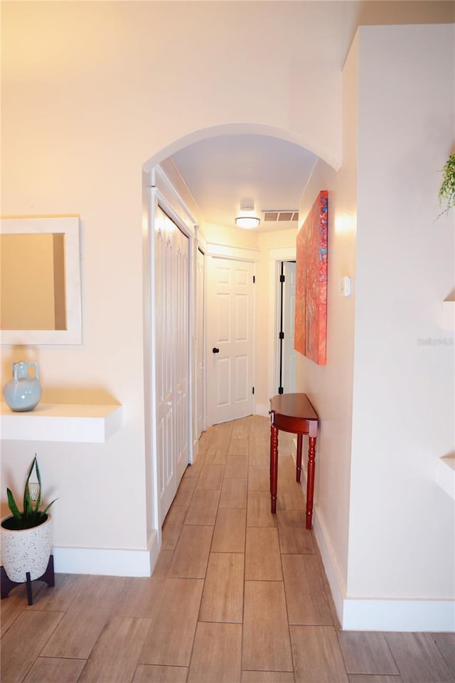 2019 Jaffa Ct, Clermont, FL 34714 - corridor featuring arched walkways and wood tiled floors