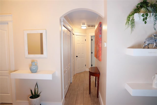 hallway with light hardwood / wood-style flooring