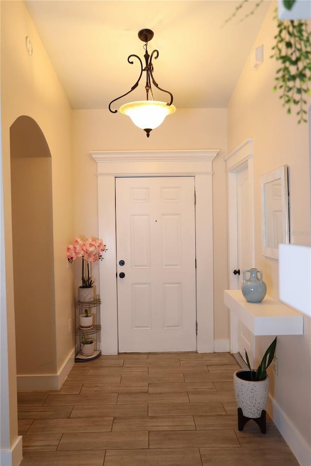 2019 Jaffa Ct, Clermont, FL 34714 - foyer entrance featuring light wood-style floors and arched walkways