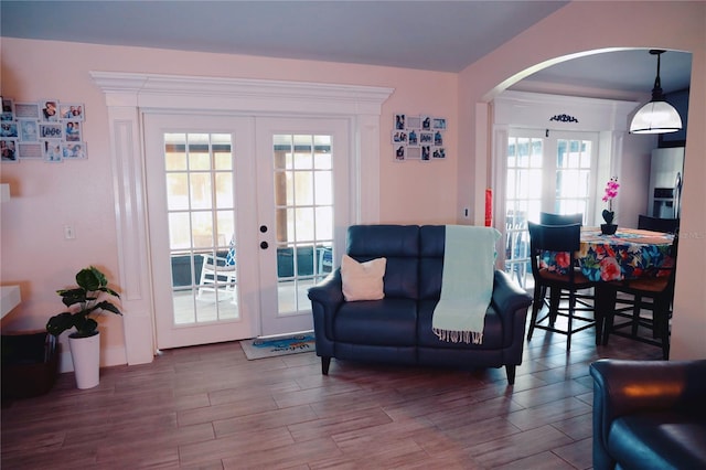 2019 Jaffa Ct, Clermont, FL 34714 - living room with french doors, arched walkways, and wood finished floors