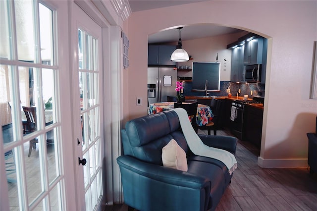 2019 Jaffa Ct, Clermont, FL 34714 - living room featuring arched walkways, healthy amount of natural light, and dark wood finished floors