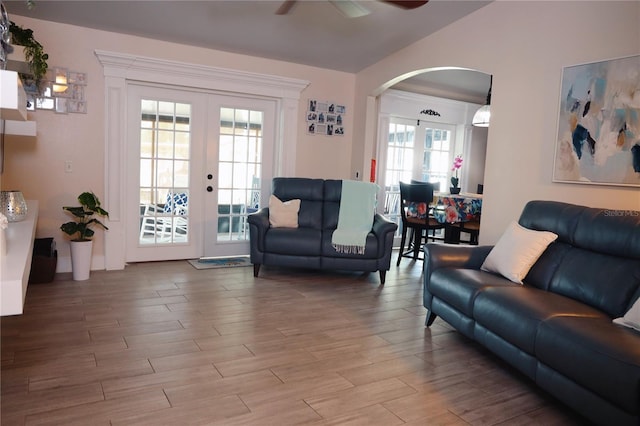 2019 Jaffa Ct, Clermont, FL 34714 - living area featuring arched walkways, a ceiling fan, french doors, wood finished floors, and vaulted ceiling