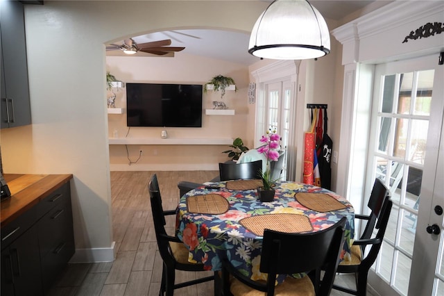 2019 Jaffa Ct, Clermont, FL 34714 - dining area featuring ceiling fan, french doors, wood finished floors, arched walkways, and vaulted ceiling