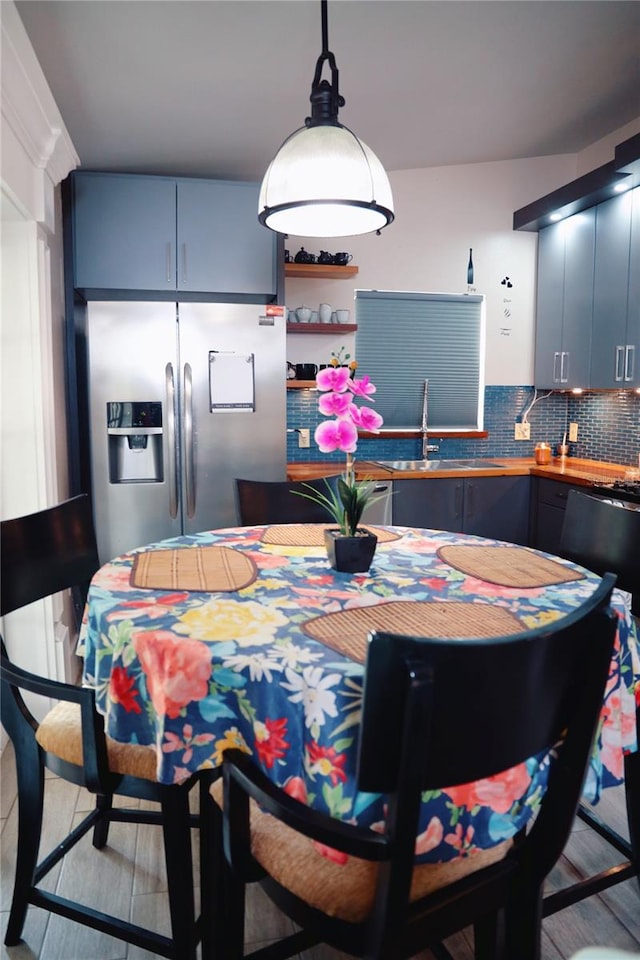 dining room featuring light wood-type flooring and sink