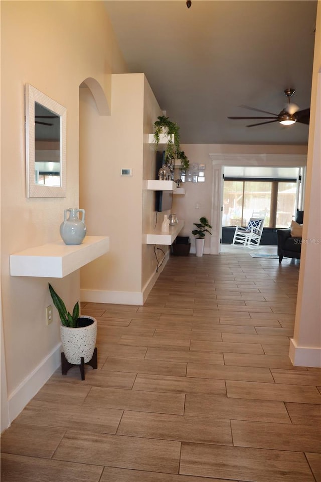 corridor with hardwood / wood-style flooring