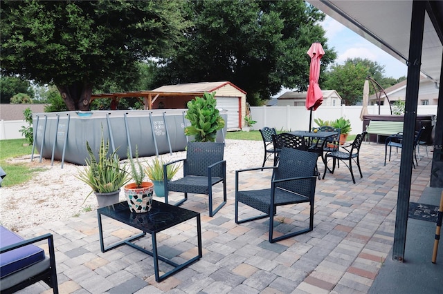 2019 Jaffa Ct, Clermont, FL 34714 - fenced backyard featuring a patio area, outdoor dining space, a storage unit, and a hot tub