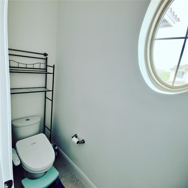 bathroom featuring tile patterned flooring and toilet