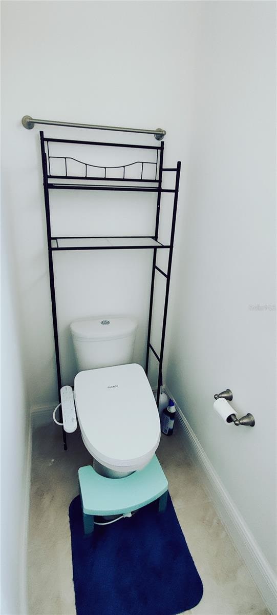 bathroom featuring toilet and concrete floors