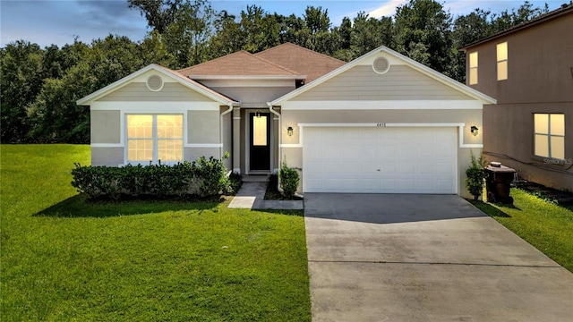 view of front of property featuring a front yard and a garage