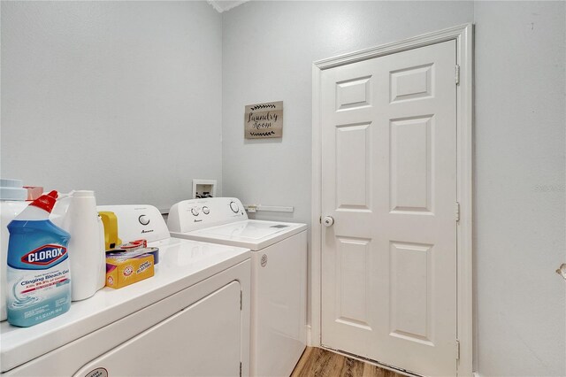 laundry area featuring independent washer and dryer and light wood-type flooring