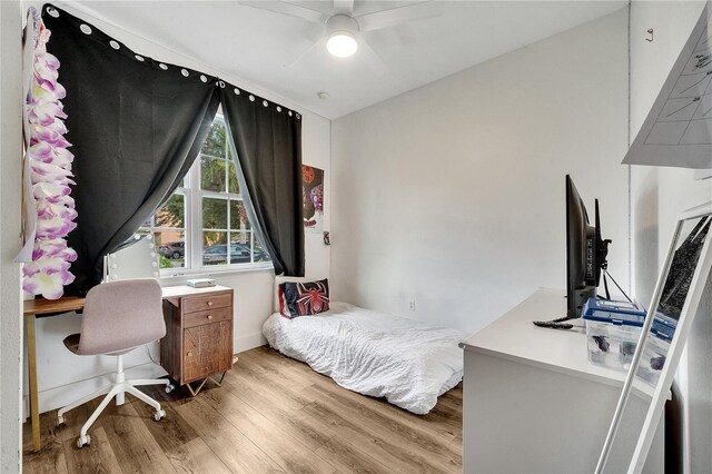 bedroom with ceiling fan and light wood-type flooring