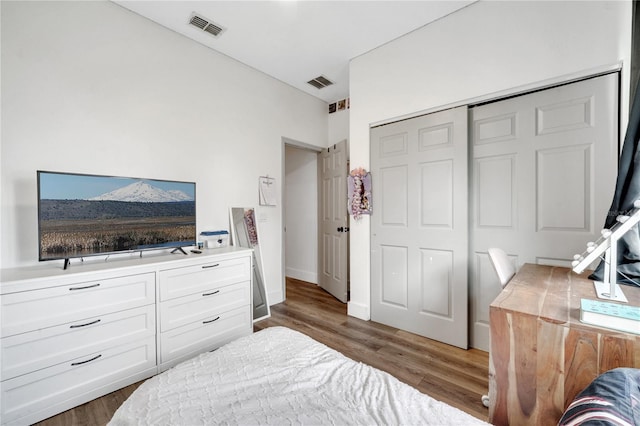 bedroom featuring dark hardwood / wood-style floors and a closet