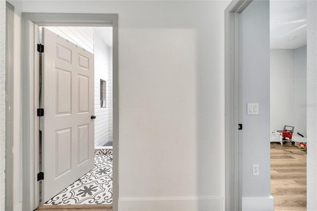 corridor with hardwood / wood-style flooring