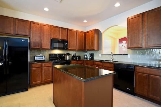 kitchen with a kitchen island, decorative backsplash, light tile patterned floors, and black appliances