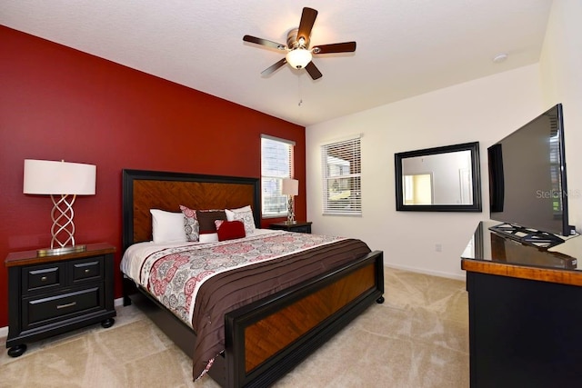 bedroom with ceiling fan and light colored carpet