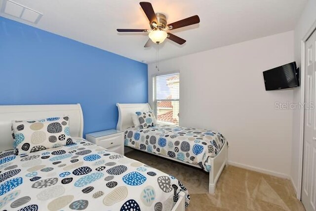 401 Cabello Dr, Davenport, FL 33837 - bedroom with light colored carpet, a closet, baseboards, and a ceiling fan