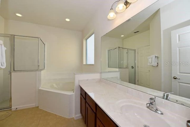 bathroom featuring tile patterned flooring, plus walk in shower, and vanity