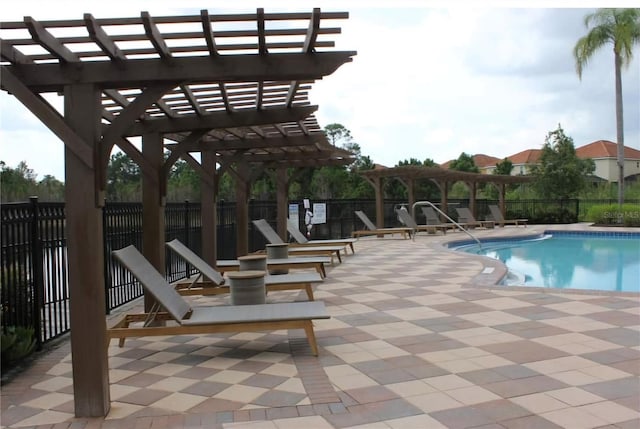 401 Cabello Dr, Davenport, FL 33837 - community pool with a pergola, fence, and a patio