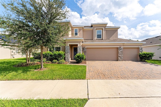 view of front of home with a garage and a front lawn