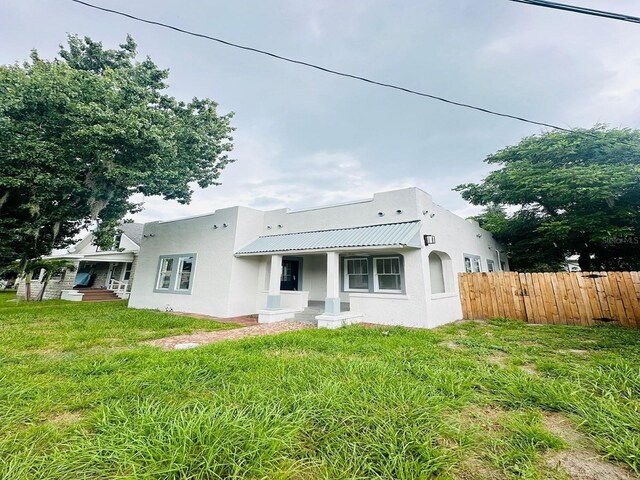 back of house featuring a yard