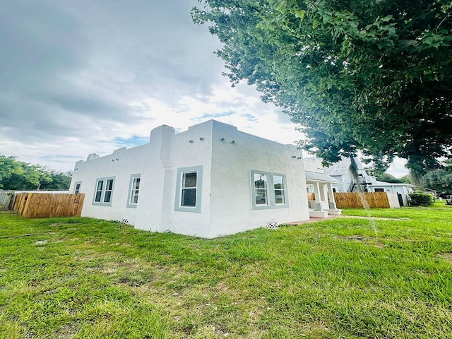 view of side of home featuring a yard