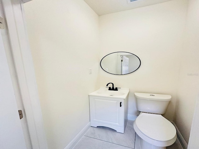 bathroom with tile patterned floors, toilet, and vanity