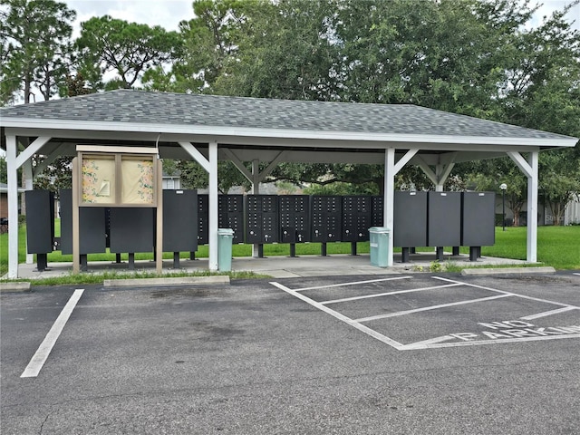 view of car parking featuring mail boxes