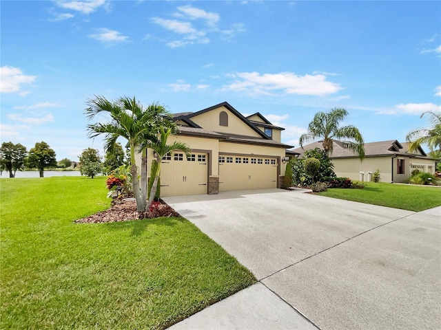 view of front of home featuring driveway, stucco siding, a garage, and a front yard