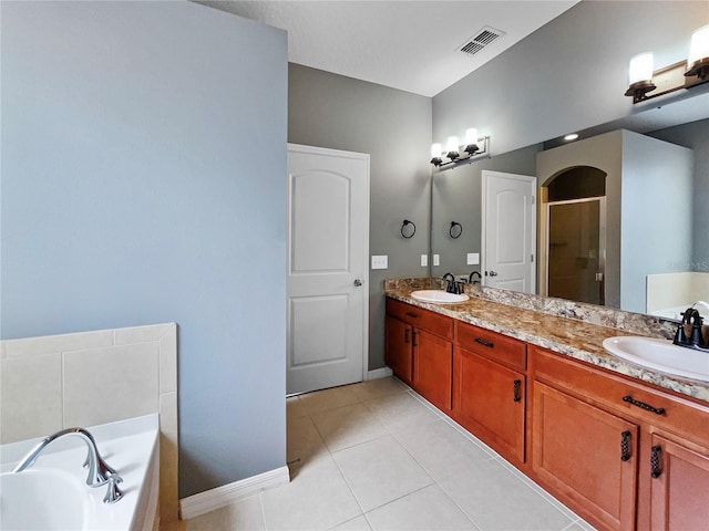 full bath featuring a stall shower, visible vents, a sink, and double vanity