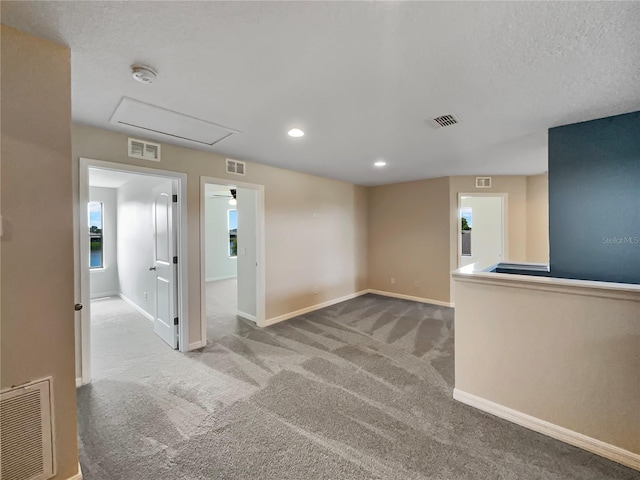 spare room featuring carpet and visible vents