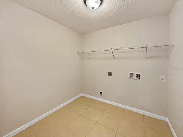 laundry area with laundry area, baseboards, hookup for a washing machine, hookup for an electric dryer, and a textured ceiling