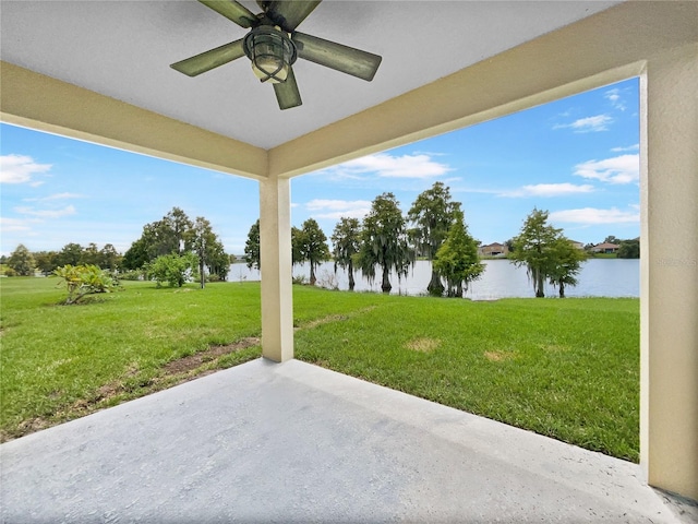 view of patio featuring a water view and ceiling fan