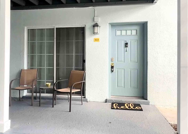 view of exterior entry with stucco siding