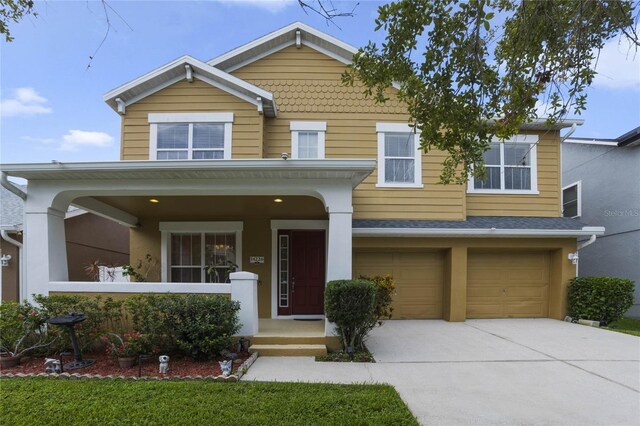 view of front facade with a garage and a porch