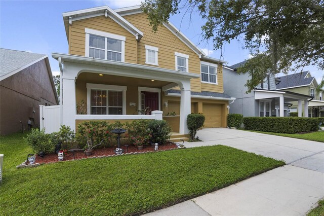 craftsman inspired home with a porch, a garage, and a front yard