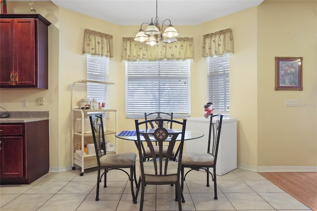 dining space featuring light wood-type flooring and a notable chandelier