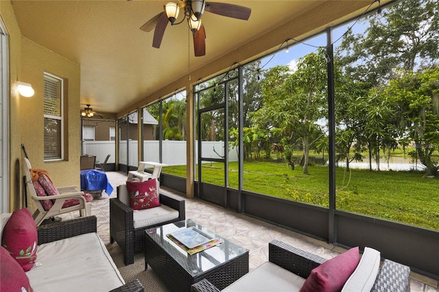 sunroom / solarium featuring ceiling fan